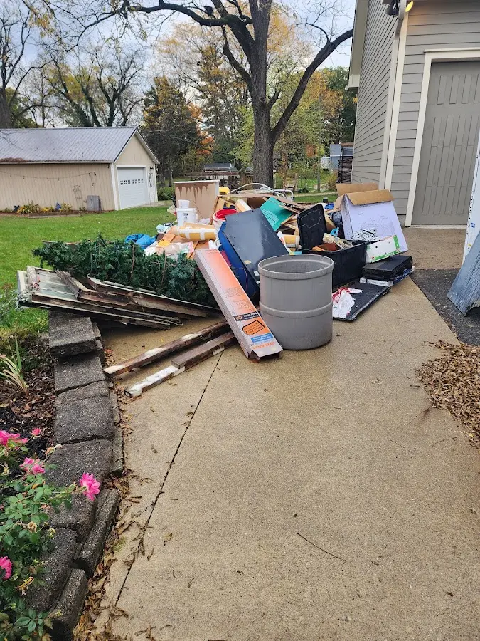 Dumpster being loaded with debris for Estate Cleanout Dumpster Rental in Shoreline